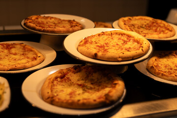 Freshly Baked Cheese Pizzas on White Plates