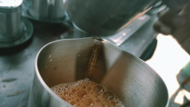 POV of the process of making Teh Tarik. Malaysian originated drink that uses tea dust and condensed milk with pulling technique.