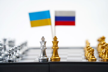 A chessboard with pieces and flags of Russia and Ukraine. Strategy, political game, and diplomacy.