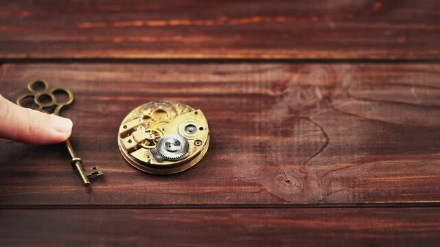 Gold key with clockwork. Success, solution, life coaching or mentorship concept.