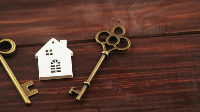 Golden keys with a house. Mortgage loan, home buying, insurance concept.
