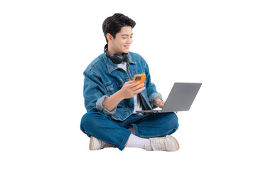 Full body image of Asian guy using laptop and phone on png background	
