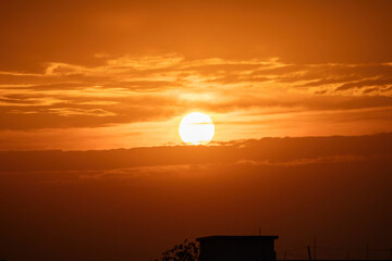 Fiery red sunset sky background. Beautiful, colorful, dramatic clouds at sunset or sunrise.