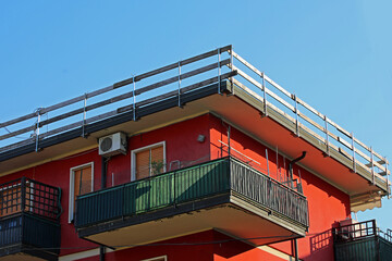 Fall protection barrier with wooden planks installed on the roof frame of condominium on the construction site during maintenance of roof