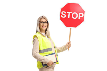 Woman holding books and a stop sign