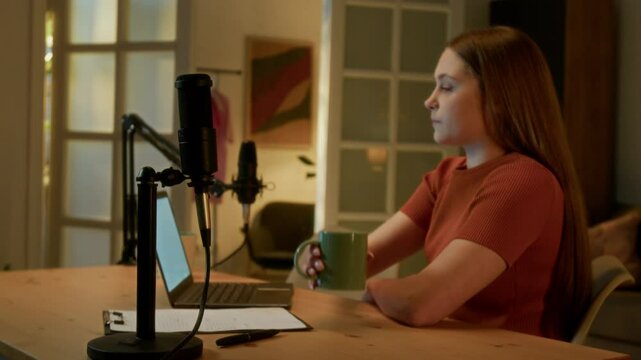 Teen girl typing on keyboard while working in spacious studio, she preparing script for new podcast