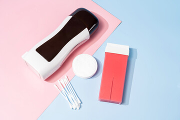 Roll on waxing supplies on pastel background