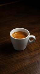 Obraz premium Minimalist Espresso Shot in White Ceramic Cup on Wooden Table with Moody Lighting