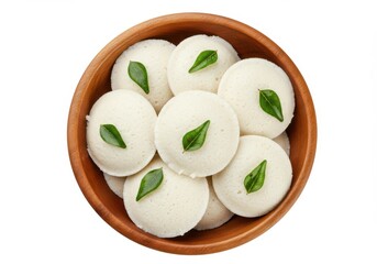 Delicious idli steamed rice cakes in wooden bowl