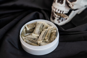 Skull Chewing Tobacco on Black Cloth. 