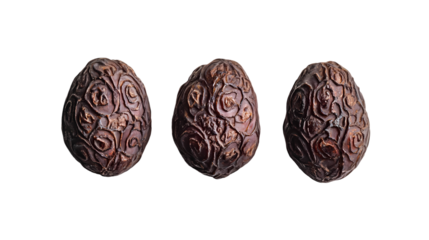 Three ornate chocolate easter eggs with rose designs on a black background in a studio shot isolated on transparent background