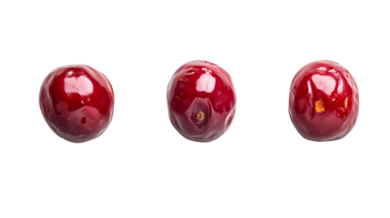 Three red cherries aligned horizontally on a black background in a studio shot with reflections isolated on transparent background