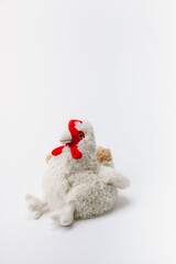 Chicken stuffed animal sitting on a white background