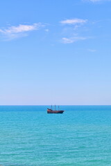 Minimalist Scene of a Pirate Ship Sailing on the Mediterranean Sea Off the Coast of Hammamet,...