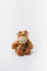 Monkey stuffed animal sitting on a white background