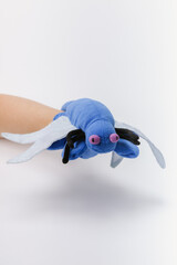 Blue bug hand puppet on a white backdrop