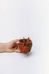 hand holding brown bunny shaped wicker basket