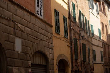 Old brick orange building wall with windows in the old europe city on the street. Italy town with vintage style
