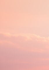 Obraz premium Soft, pastel pink sunset sky with wispy clouds