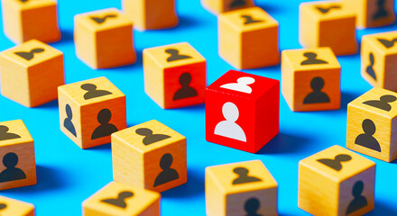 Wooden blocks with person icons in yellow and one red block on a bright blue surface arranged randomly