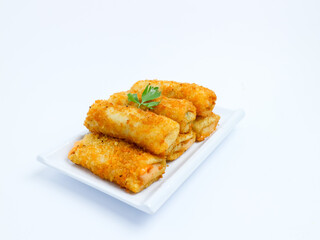 Indonesian crispy risol mayo filled with sausage and soft mayonnaise, served on a white plate with parsley garnish on a white background. Perfect photo of a traditional snack.