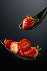 Fresh strawberries on a black background.