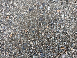 Gravel and Pebble Ground Texture Close-Up. Natural gravel and small pebble ground texture close-up. Earthy tones and mixed stone sizes perfect for backgrounds