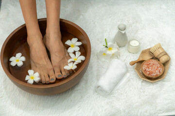Panorama top view woman indulges in blissful foot massage at luxurious spa salon while masseur give reflexology therapy in gentle day light ambiance resort or hotel foot spa. Quiescent