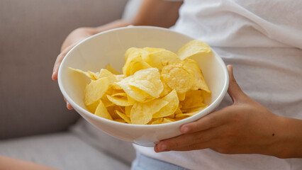 Close-Up of a Bowl of Crispy Potato Chips Held by a Person