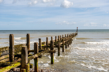 Wooden groynes and sea breakers protecting the  North Norfolk cliffs from coastal erosion