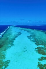 Ocean Divide: An aerial view showcases a breathtaking expanse of azure waters and an unseen, expansive ocean. A natural wonder where the blue sky meets the tranquil sea