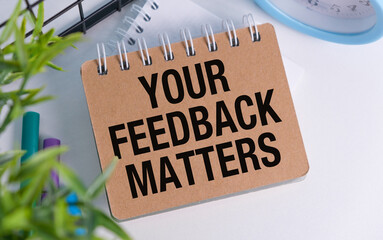 A brown notebook with the words Your Feedback Matters written on it