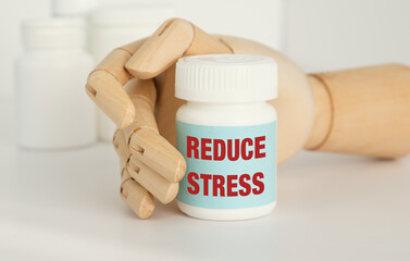 A hand holding a bottle of medicine that says Reduce Stress