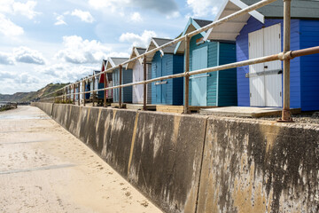 Colourful beach huts along the promenade in the seaside village of Overstrand on the North Norfolk coast