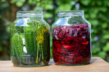 Jars Of Pickled Cucumbers And Beetroots