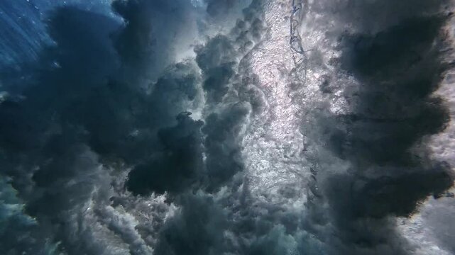 Powerful wave breaks underwater turbulence, wave crashing on the corral reef in tropical ocean. spinning vortex. powerful nature, strong wave. slow motion 4k.