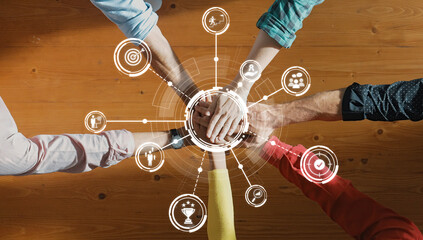 A dynamic scene showcasing diverse hands uniting over a table, surrounded by digital icons...