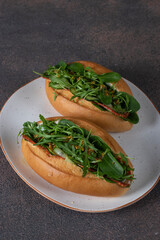 Homemade sandwiches with sausage, cucumber, arugula and spinach for breakfast
