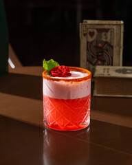 Fancy Red Colour Cocktail with a Rose Garnish in a Dark Moody background