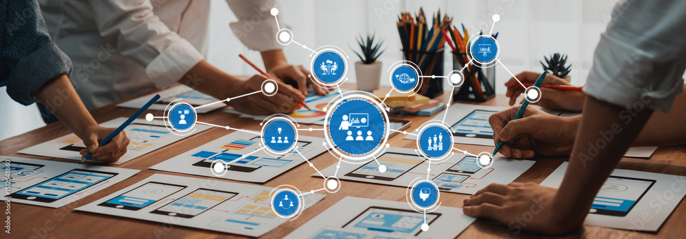 Fototapete Engaging scene showcasing hands working on design papers in a collaborative workspace, highlighting teamwork and the creative process with digital elements. Amity
