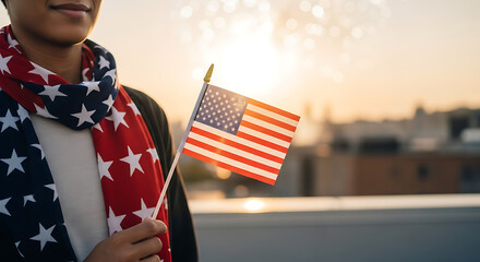 Celebrating independence with a small American flag at sunset