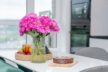Breakfast: buckwheat tea, poppy seed cake and peonies on the table