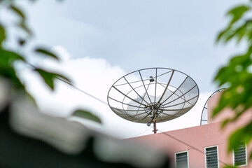 Satellite Dish on Roof Under Cloudy Sky