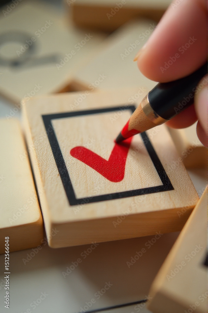 Poster A person uses a pencil to create a check mark on a wooden block, providing a simple yet effective marking solution