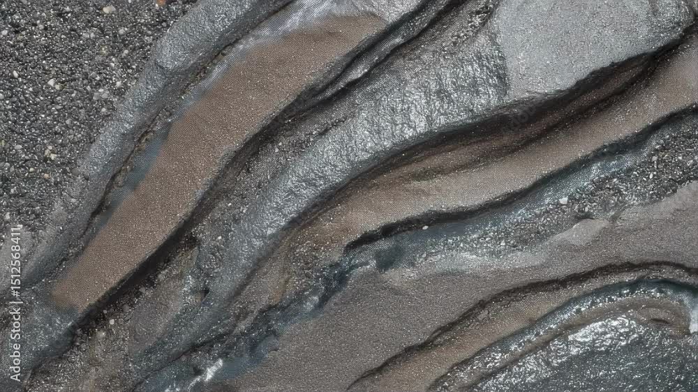 Poster glassy plasma glaze lines creating sharp visual contrast against rugged basalt shingle surface, reve
