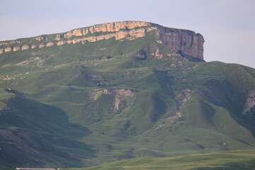 green slopes of a beautiful cliff on a summer day