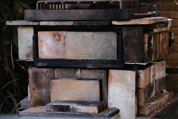 Process of baking rustic bread: Preparing the oven with coal and wood