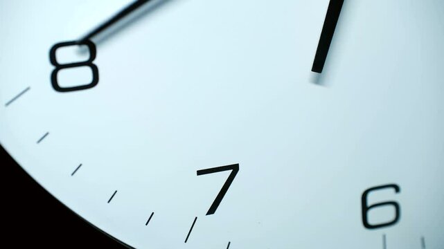 White clock face with black hands slowly moving from seven to almost eight o'clock, capturing precise time progression through minimalist design and smooth timelapse movement
