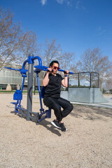 Woman exercising with outdoor gym equipment in a park