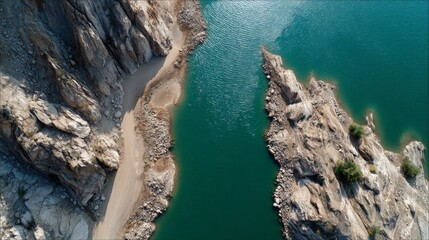 Aerial View of Lake Between Rock Cliffs and Shoreline